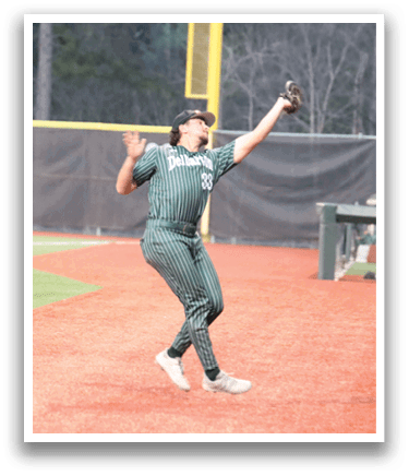 A woman wearing a green shirt and white shoes catching a baseball. Description generated by AI