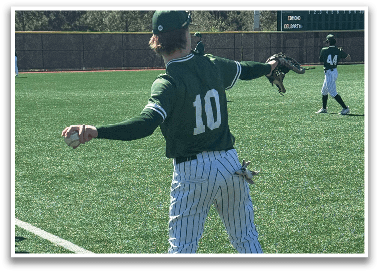 A baseball player wearing a green and white uniform with the number 10 on the back. Description generated by AI
