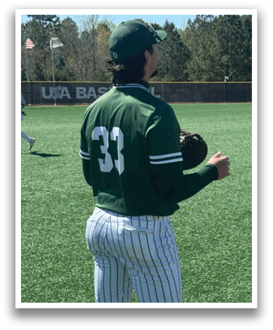 A baseball player wearing a green and white uniform. Description generated by AI