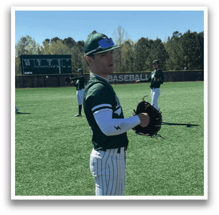 A baseball player standing on a field with a glove. Description generated by AI