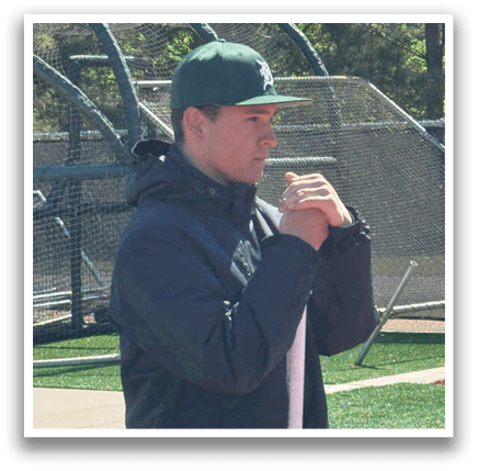 A man standing on a baseball field holding a bat. Description generated by AI