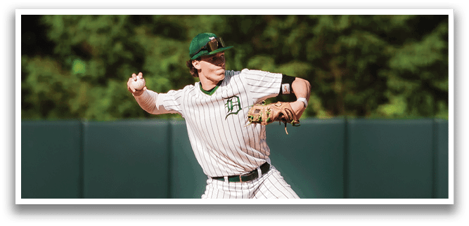 A baseball player is at bat, holding a bat and wearing a black and white uniform. Description generated by AI
