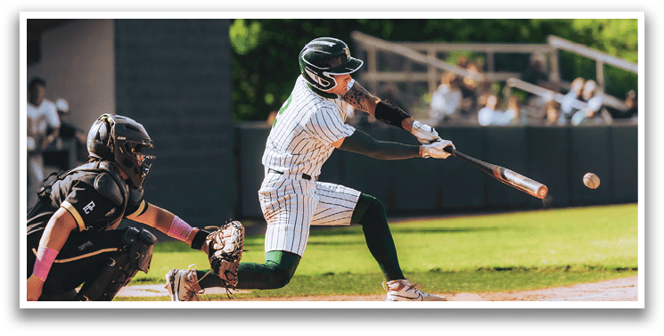 A baseball game is taking place with a man in a black shirt and gray pants standing behind a catcher. Description generated by AI