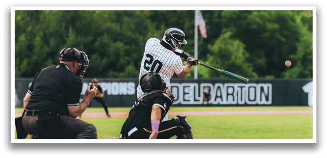 A baseball player is at bat, holding a bat and wearing a black and white uniform. Description generated by AI