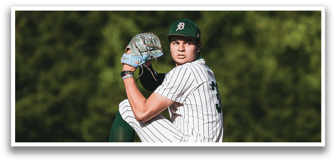 A baseball player is at bat, holding a bat and wearing a black and white uniform. Description generated by AI