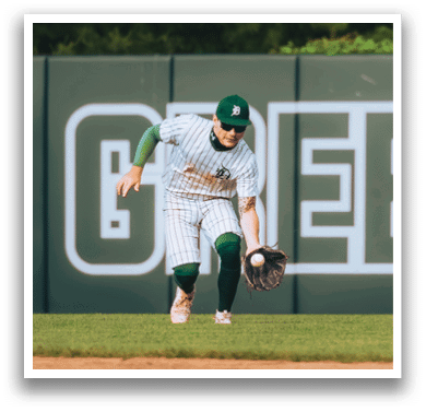 A baseball player is standing on the field. Description generated by AI
