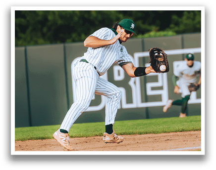 A baseball player is sliding into home plate. Description generated by AI