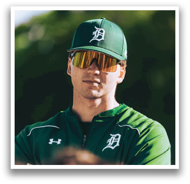 A baseball player is standing on the field. Description generated by AI