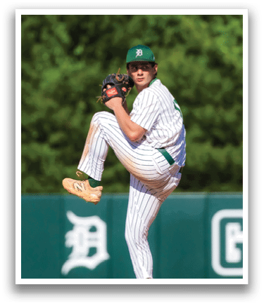 A baseball player is swinging a bat on a field. Description generated by AI