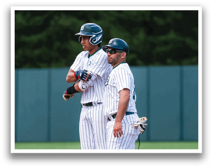 A baseball player is holding a bat and getting ready to swing. Description generated by AI