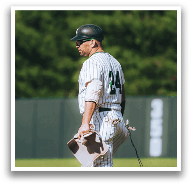 A baseball player is standing on the field. Description generated by AI