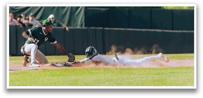 A baseball player is at bat, holding a bat and wearing a black and white uniform. Description generated by AI