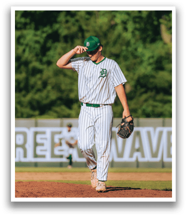 A baseball player is standing on the pitcher's mound. Description generated by AI