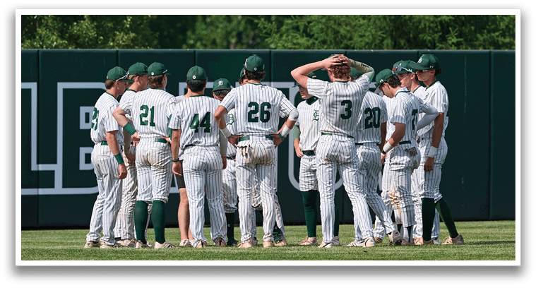 A group of young men in green and white uniforms pose for a picture. Description generated by AI