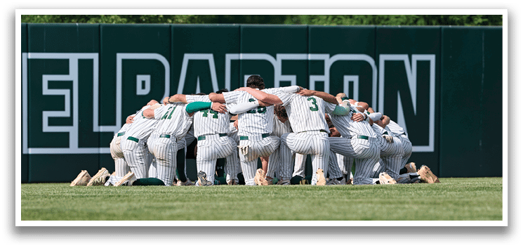 A group of young men wearing green and white uniforms. Description generated by AI