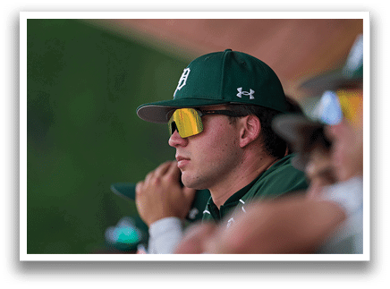 A man wearing a green jacket with a hood on his head. Description generated by AI