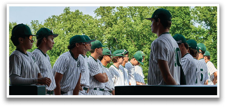 A group of people wearing green and white shirts. Description generated by AI