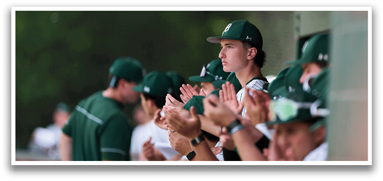 A group of young men wearing green and white uniforms. Description generated by AI