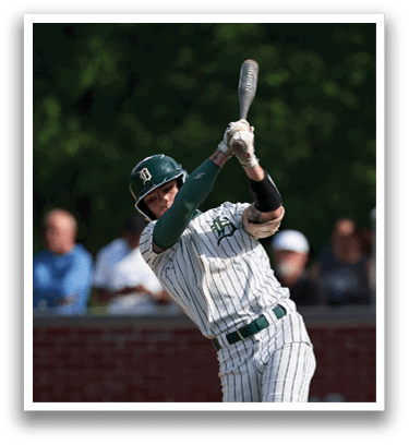 A man holding a lacrosse stick. Description generated by AI