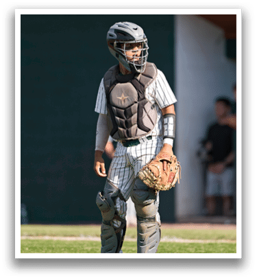A man holding a lacrosse stick. Description generated by AI