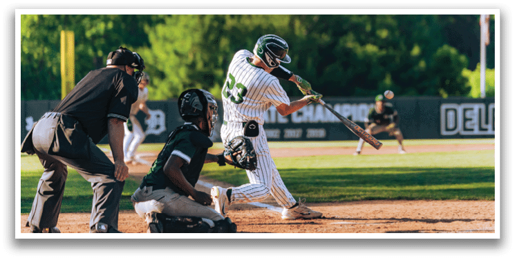 A baseball player is at bat, holding a bat and waiting for the pitch. Description generated by AI