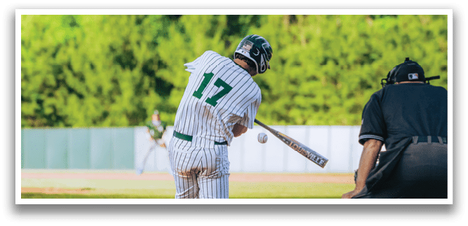 A baseball player is swinging a bat at a ball. Description generated by AI