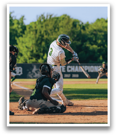 A baseball player is swinging a bat on a field. Description generated by AI
