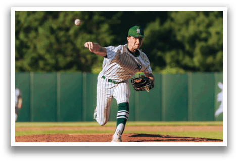 A baseball player is at bat, wearing a black and white uniform. Description generated by AI
