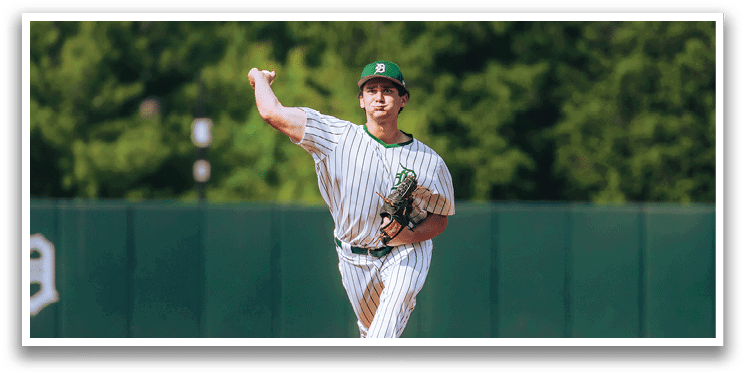 A baseball game is taking place with a man in a black shirt and gray pants standing behind a catcher. Description generated by AI