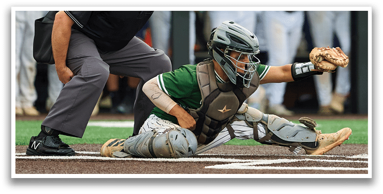 A baseball game is taking place with a man in a black shirt and gray pants standing behind a catcher. Description generated by AI