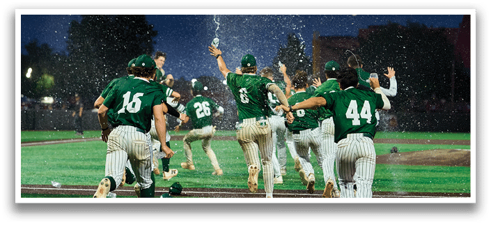 A man and woman are standing on a field with a football player in a green and white uniform. Description generated by AI