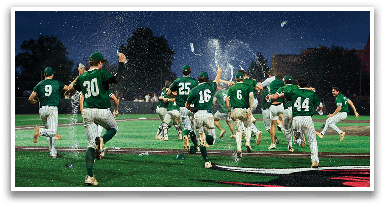 A group of young men in green and white uniforms pose for a picture. Description generated by AI