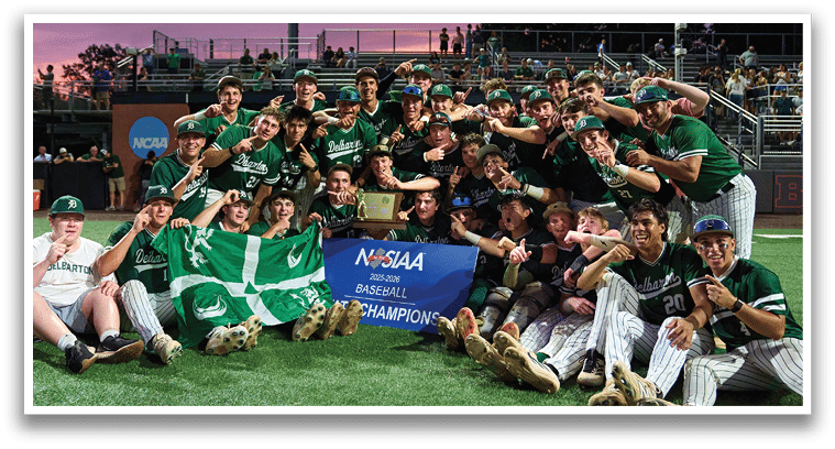 A group of young men in green and white uniforms pose for a picture. Description generated by AI