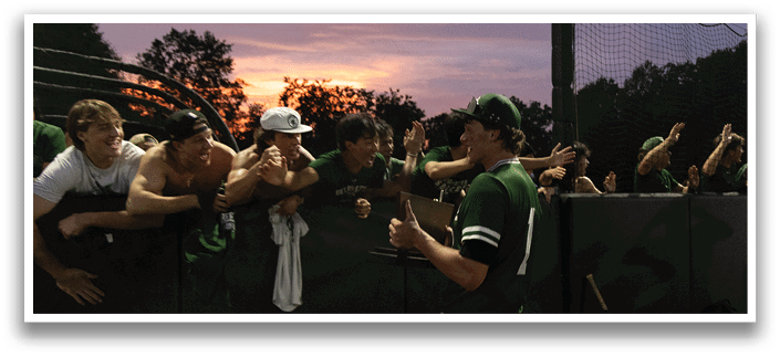 Five men wearing green jerseys with the number 11, 18, 19, 24, and 34 on them. Description generated by AI