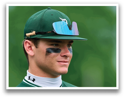 A man wearing a green jacket with a hood on his head. Description generated by AI