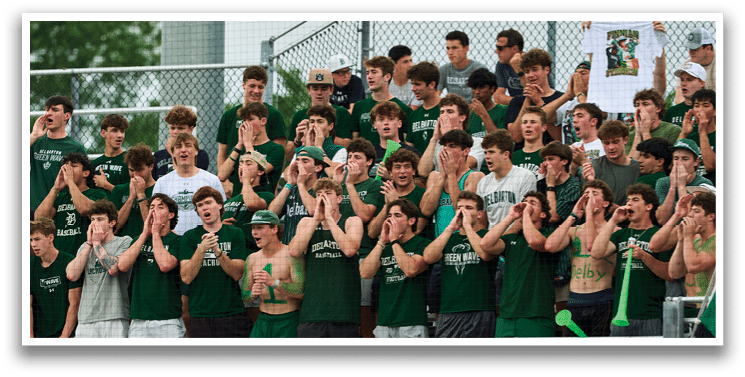 A group of people wearing green and white shirts. Description generated by AI