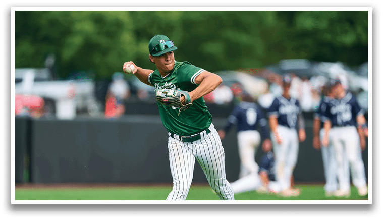 A group of young men in green and white uniforms pose for a picture. Description generated by AI