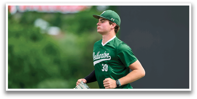 A group of young men wearing green and white uniforms. Description generated by AI