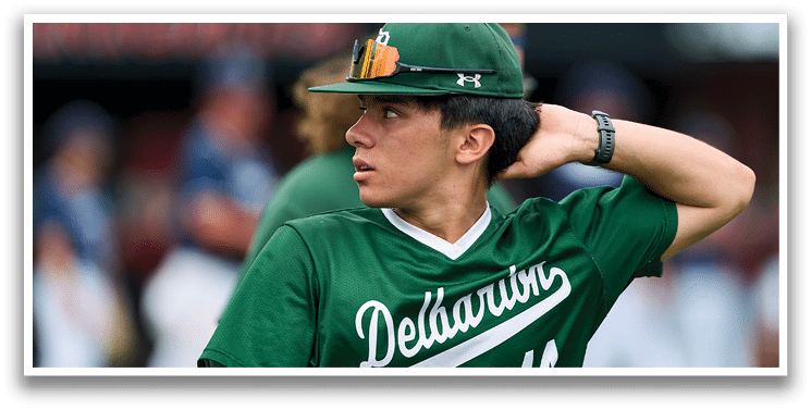 A group of young men wearing green and white uniforms. Description generated by AI
