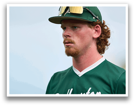 A man wearing a green jacket with a hood on his head. Description generated by AI