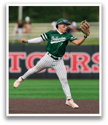 A baseball player is swinging a bat on a field. Description generated by AI