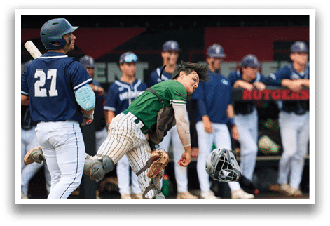 A baseball player is at bat, wearing a black and white uniform. Description generated by AI
