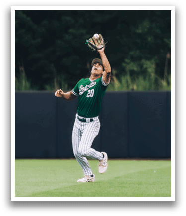 A baseball player is standing on the pitcher's mound. Description generated by AI