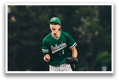 A baseball player in a black shirt and black socks is bending over to catch a ball. Description generated by AI