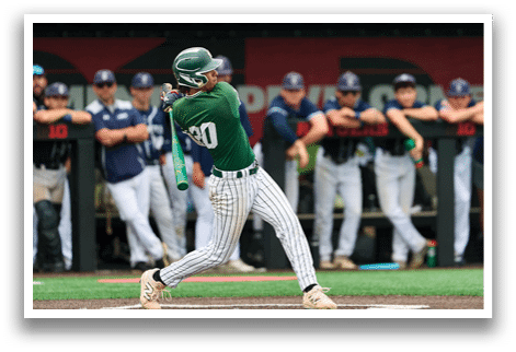 A baseball player is at bat, wearing a black and white uniform. Description generated by AI
