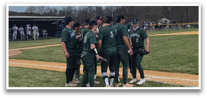 A baseball player in a green shirt and black pants is leaning over to catch a ball. Description generated by AI