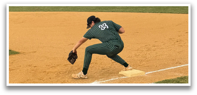 A group of men wearing green and white uniforms are standing on a baseball field. Description generated by AI