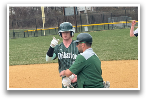 A baseball player wearing a green and white uniform is talking to an umpire. Description generated by AI