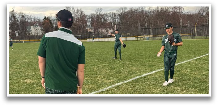 A man holding a bat on a baseball field. Description generated by AI