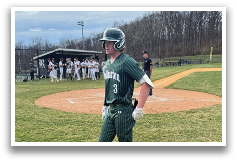 A baseball player wearing a green and white uniform. Description generated by AI
